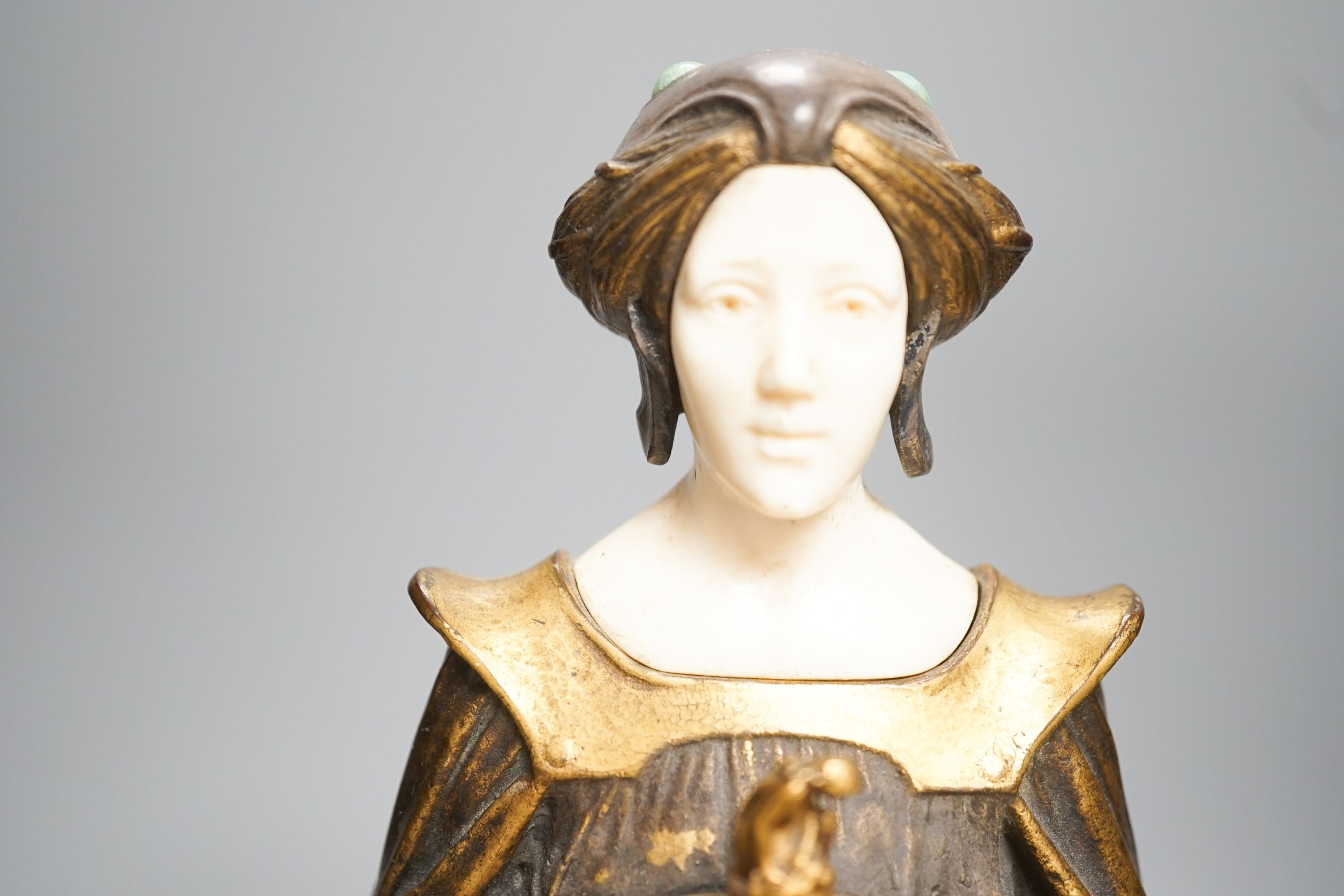 A German Art Nouveau bronze and ivory figure of Pandora, with inset carved ivory head and hands on polished stone and cut wood base, signed F. Jahn, 41cm high